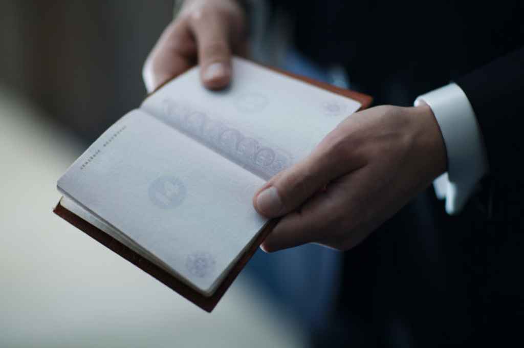 Ženin drži svoj potni list, ker ga mora pokazati matičarju. Foto: Storija weddings